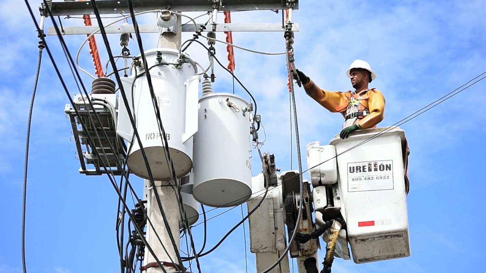 Worker In Cherry-Picker working on Power lines